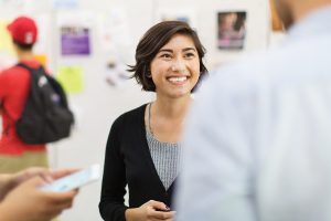 Young woman smiling and talking to someone